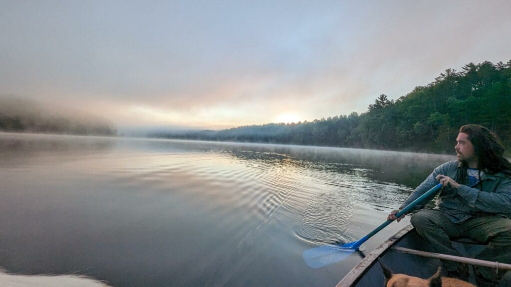 man paddling a bot on a Foggy Lake